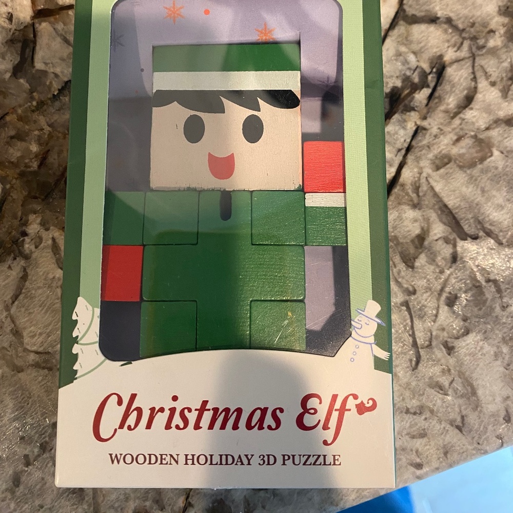 Christmas elf wooden elf puzzle toy in original packaging.